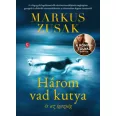 A képen a Három vad kutya és az igazság című könyv látható elmosódott háttér előtt ami egy utat ábrázol.