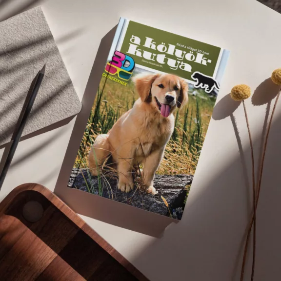 A képen A kölyökkutya 3D című könyv látható egy labradorral a háttérben.