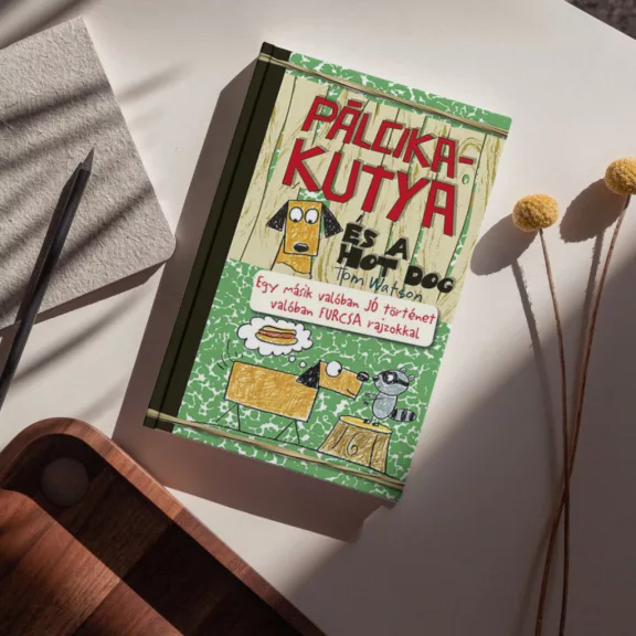 A képen a Pálcikakutya és a hot dog című könyv látható a háttérben kutyákkal és virslikkel.