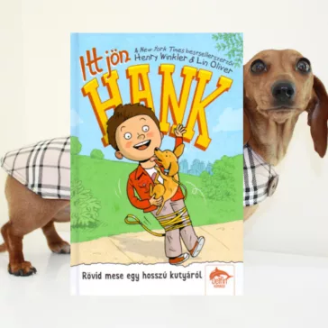 A képen az Itt jön Hank című könyv látható a háttérben egy tacskó.
