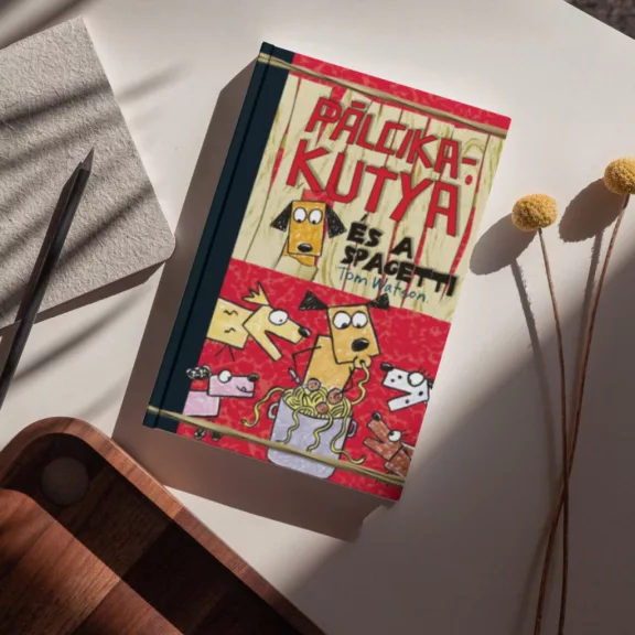 A képen a Pálcikakutya és a spagetti című könyv látható a háttérben spagettiból készült kutyákkal.