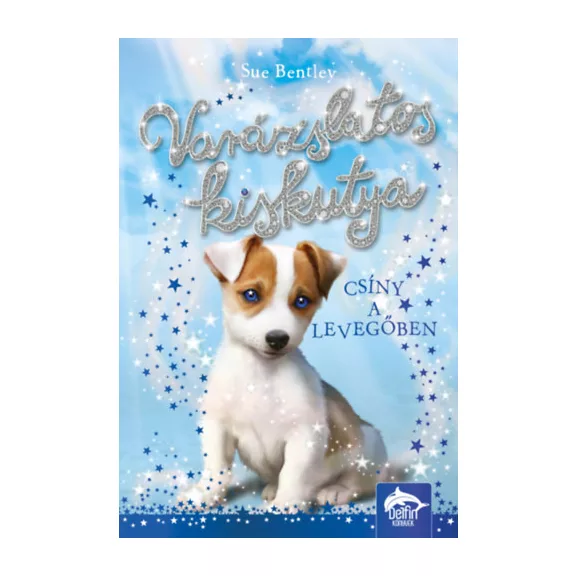 A képen a Varázslatos kiskutya című könyv látható a háttérben egy foxterrier.