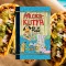 A képen a Pálcikakutya és a taco című könyv látható a háttérben három taco.