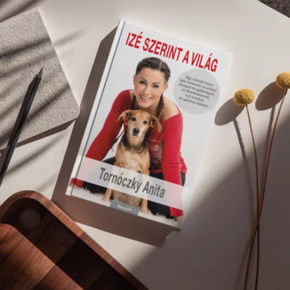 A képen az Izé szerint a világ című könyv látható egy kutyával a háttérben.