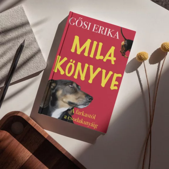 A képen Mila könyve A Farkastól a csodakutyáig című könyv látható a háttérben egy tacskóval.
