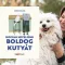 A képen a Hogyan neveljünk boldog kutyát című könyv látható a háttérben egy kutyáját ölelő nő.