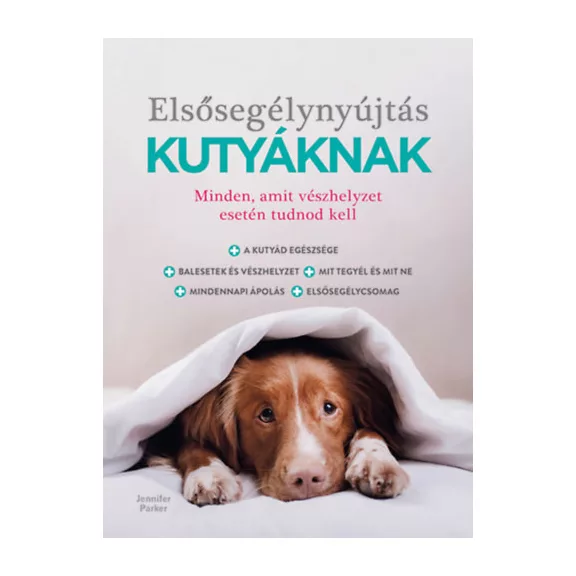 A képen az Elsősegélynyújtás kutyáknak című könyv látható a háttérben egy takaróba bugyolált kutyával.