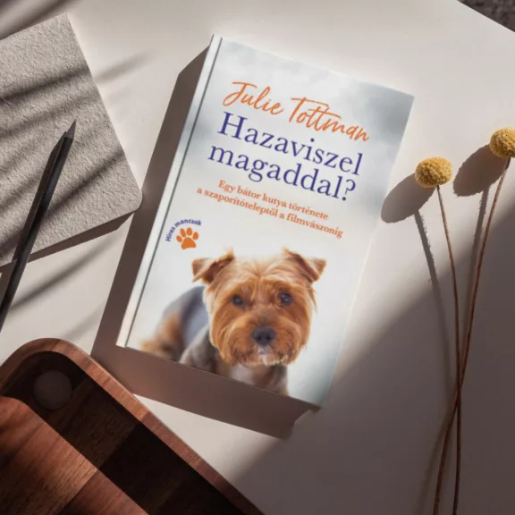 A képen a Hazaviszel magaddal című könyv látható a háttérben egy yorkival.