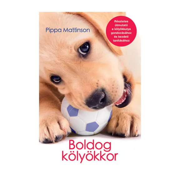 A képen a Boldog kölyökkor című könyv látható a háttérben egy labrador kölyök.