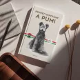 A képen a Nemzeti kincsünk A pumi című könyv látható a háttérben egy pumival.