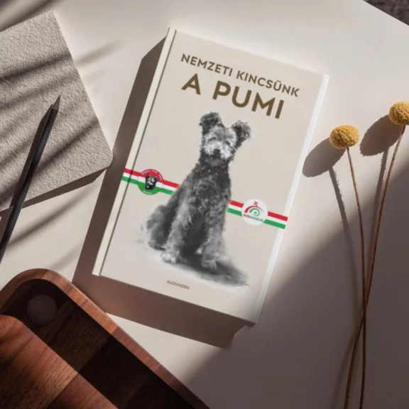A képen a Nemzeti kincsünk A pumi című könyv látható a háttérben egy pumival.
