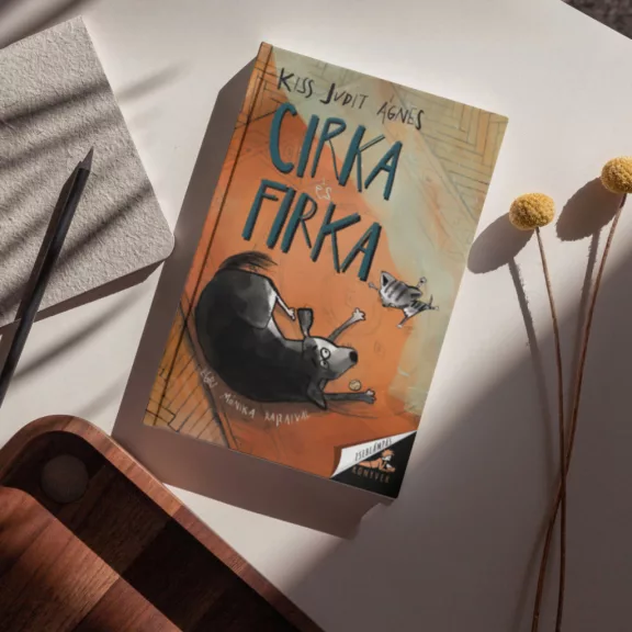 A képen a Cirka és Firka című könyv látható a háttérben két macska.