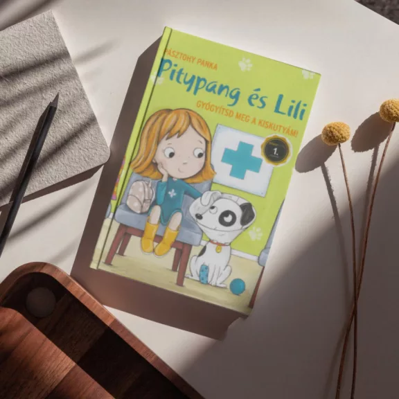 A képen a Gyógyítsd meg a kiskutyám című könyv látható a háttérben tappancs nyomokkal.