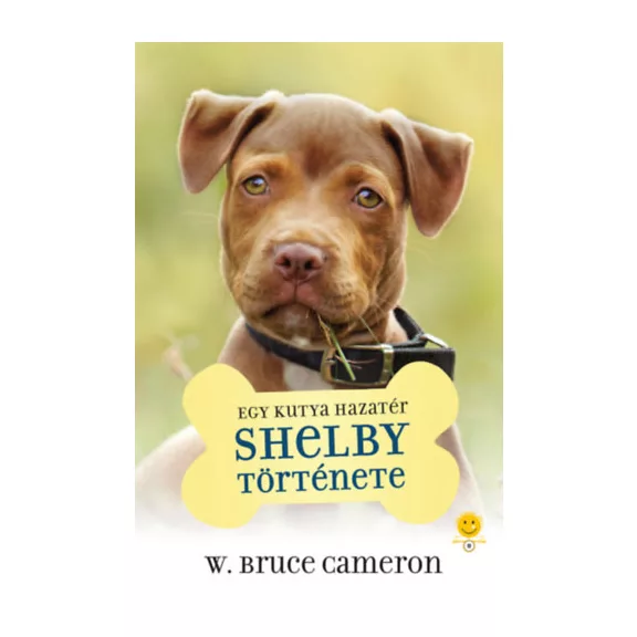 A képen az Egy kutya hazatér Shelby története című könyv látható a háttérben egy pitbull.