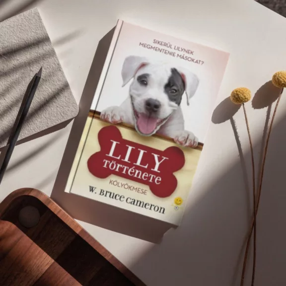 A képen a Lily története című könyv látható a háttérben egy pitbull.