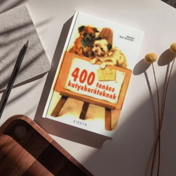 A képen a 400 tanács kutyabarátoknak című könyv látható egy kutyával a háttérben.