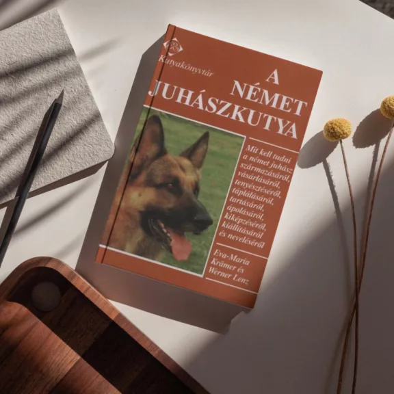 A képen A német juhászkutya című könyv látható kutyás témájú háttérrel.